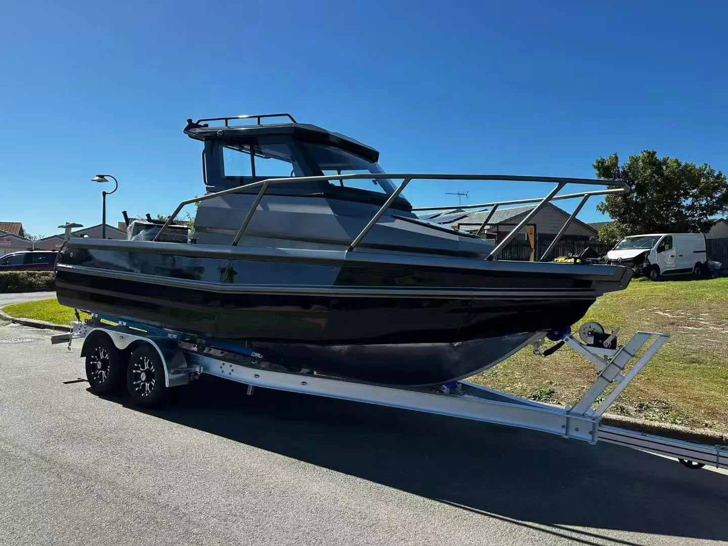 Black and silver hardtop fishing boat on a trailer